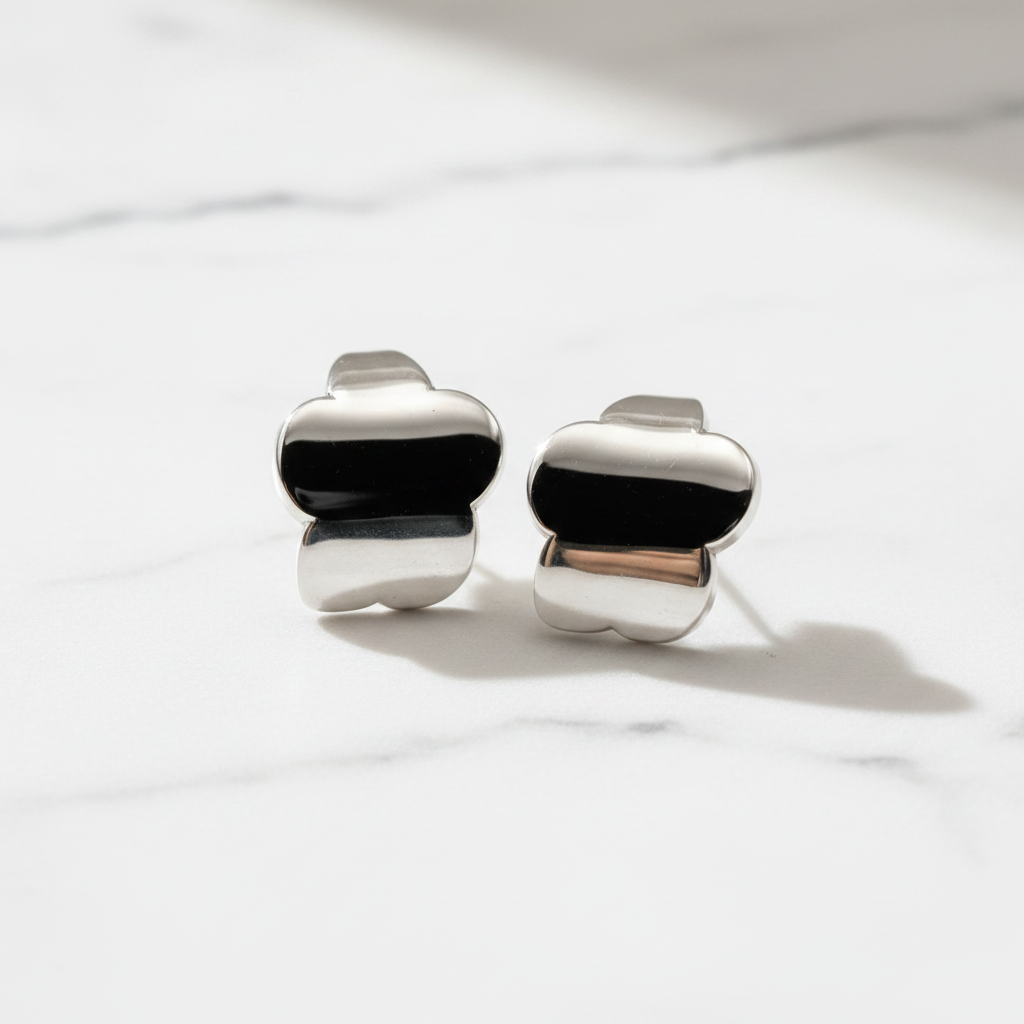 Silver and Black Enamel Chunky Heart Stud Earrings on White Marble